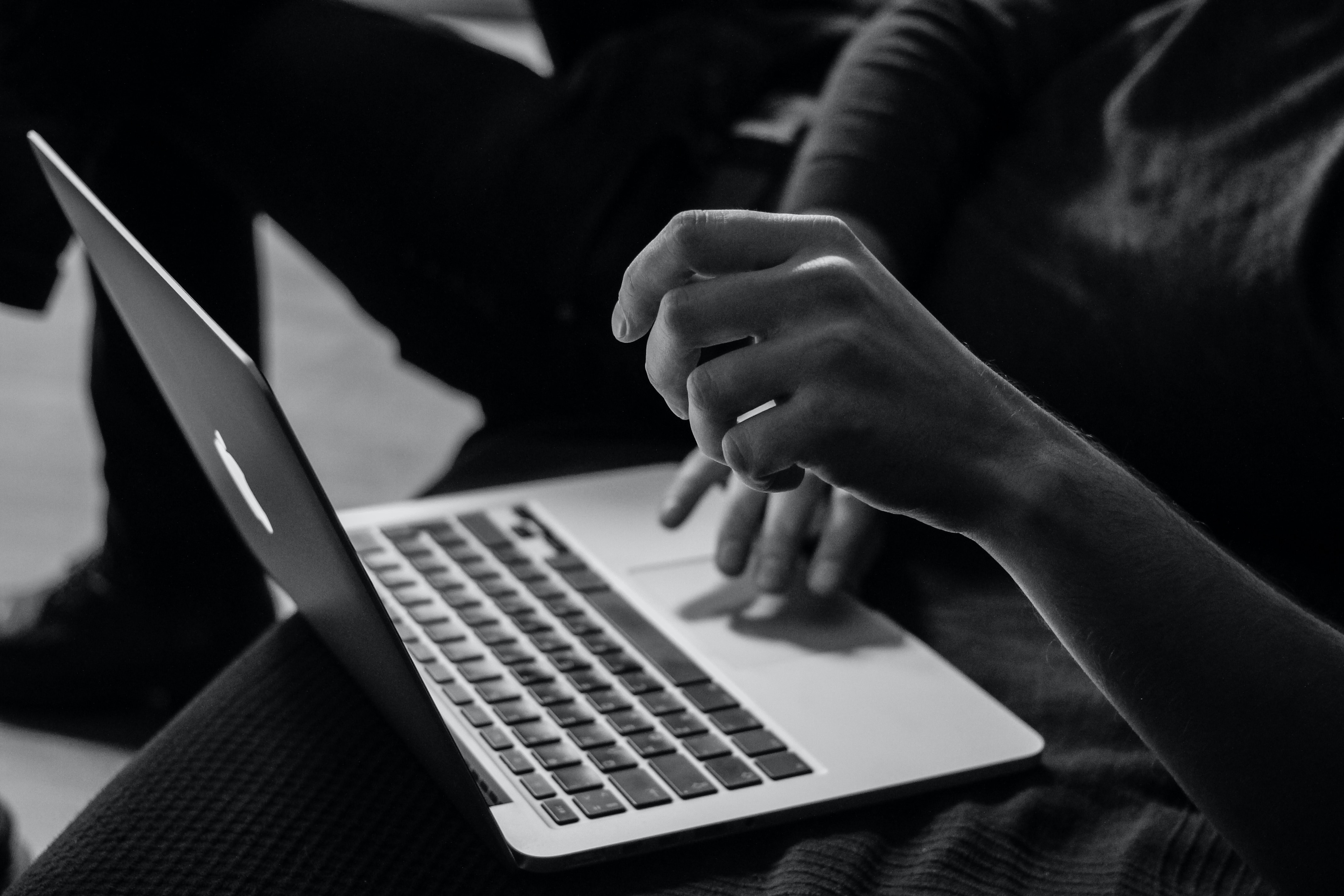 Student pointing at a computer screen in a black and white image 