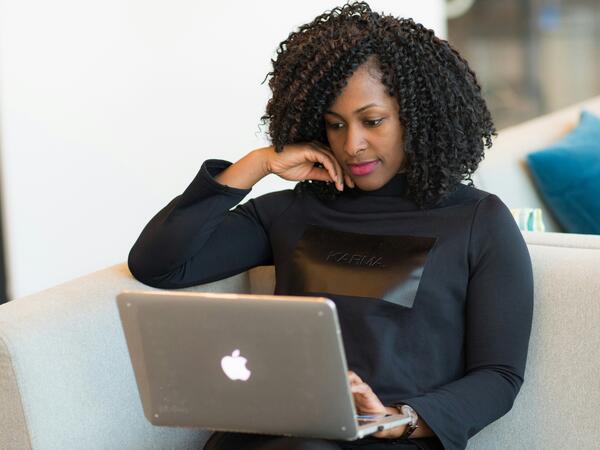 Woman sitting down using a laptop