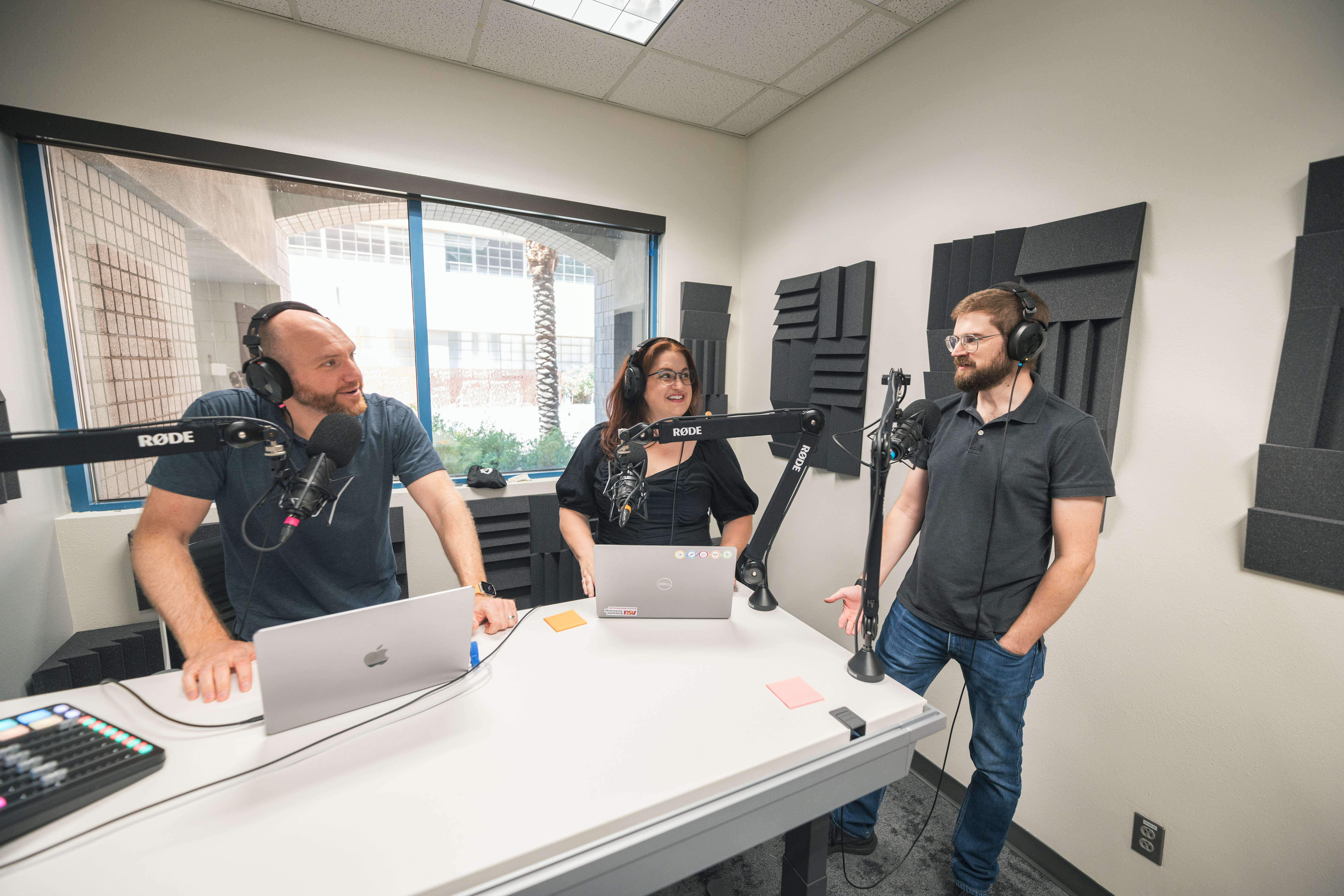 Three people in a podcasting studio