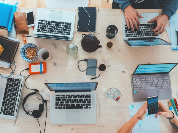 People sitting at a table using computers.